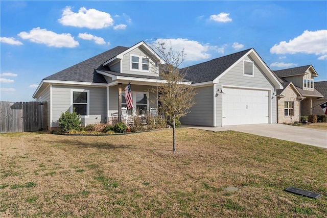 view of front of home featuring fence, roof with shingles, concrete driveway, a front yard, and a garage