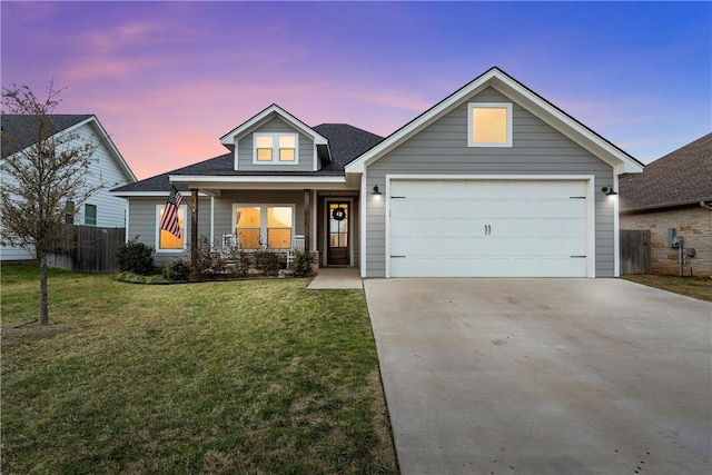 view of front of property with an attached garage, fence, covered porch, a yard, and driveway