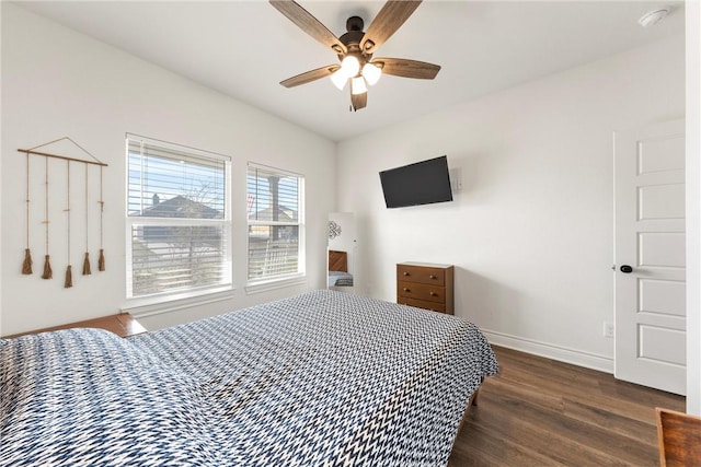 bedroom with wood finished floors, baseboards, and ceiling fan