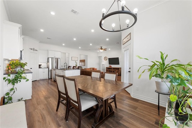 dining space featuring recessed lighting, visible vents, dark wood-style flooring, and ceiling fan with notable chandelier