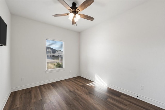 unfurnished room with a ceiling fan, dark wood-style floors, and baseboards