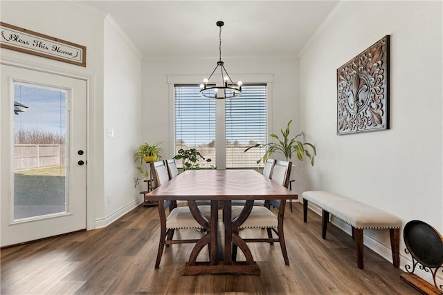 dining room featuring plenty of natural light, a notable chandelier, and dark wood-style flooring