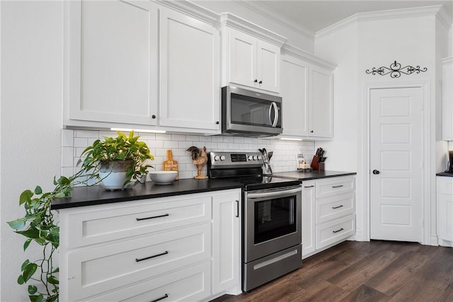 kitchen featuring dark wood-type flooring, ornamental molding, backsplash, dark countertops, and stainless steel appliances