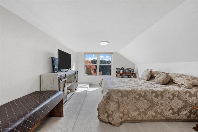 carpeted bedroom featuring vaulted ceiling