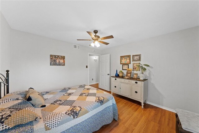 bathroom featuring hardwood / wood-style floors, a textured ceiling, vaulted ceiling, toilet, and vanity