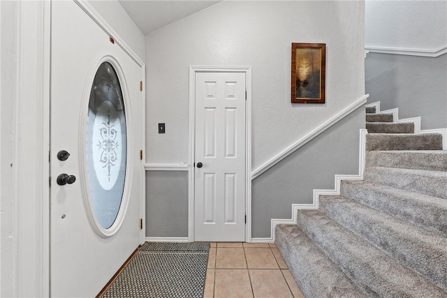 entryway with light tile patterned flooring