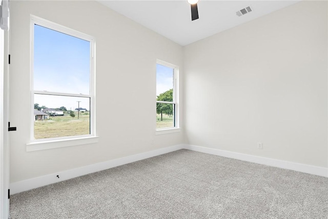 empty room featuring carpet floors and ceiling fan