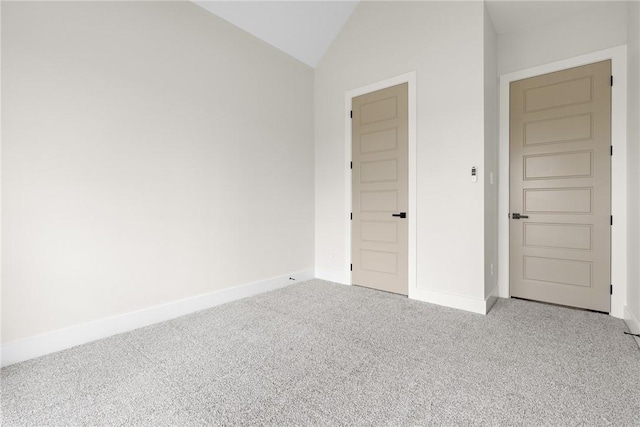 unfurnished bedroom featuring light colored carpet and vaulted ceiling