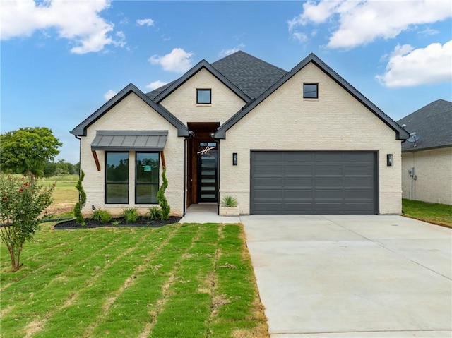 view of front of house with a front yard and a garage