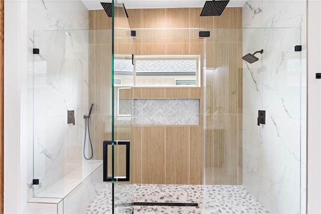 bathroom featuring a shower with door