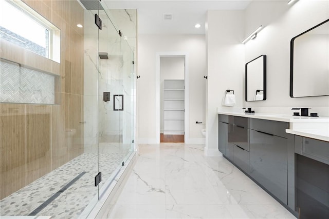 bathroom with vanity, an enclosed shower, and toilet