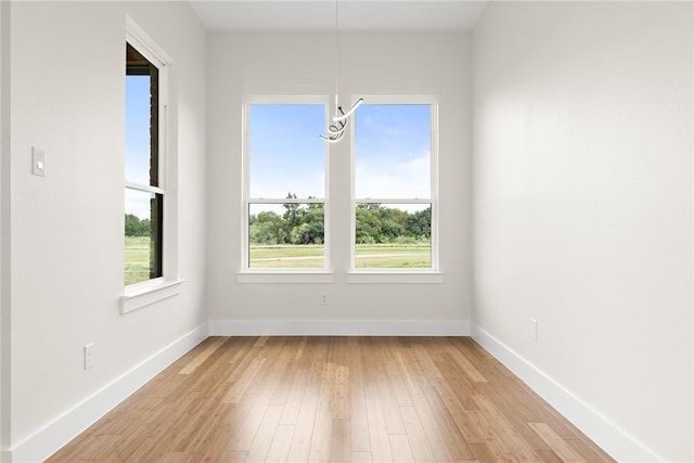 empty room with light hardwood / wood-style flooring