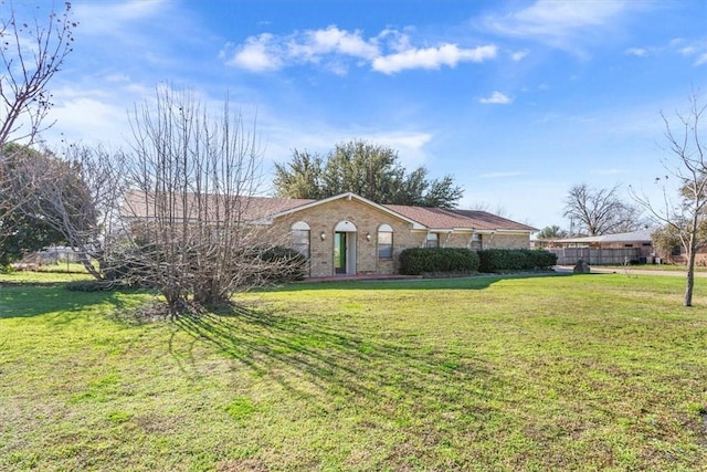 ranch-style house with a front lawn