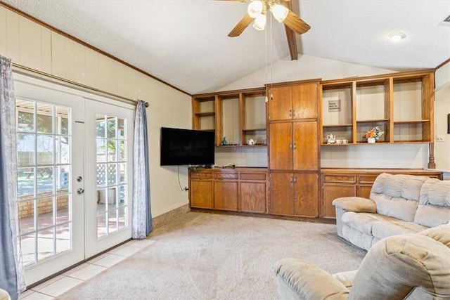 carpeted living room with french doors, lofted ceiling with beams, a textured ceiling, and ceiling fan