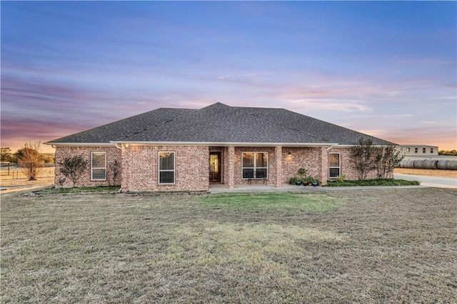 view of front of property featuring a patio area and a yard