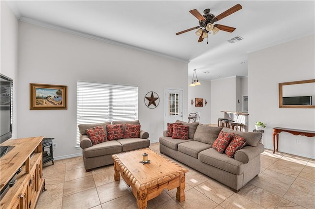 tiled living room with ceiling fan with notable chandelier and crown molding