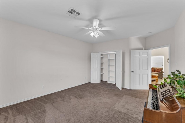 unfurnished bedroom with ceiling fan and carpet floors