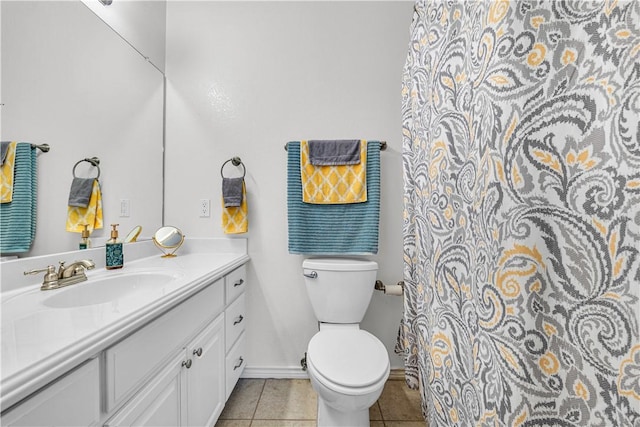 bathroom with tile patterned floors, vanity, and toilet