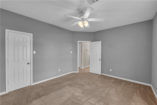 spare room featuring ceiling fan and light colored carpet