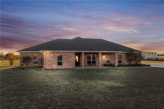 view of front of house with a yard and a patio