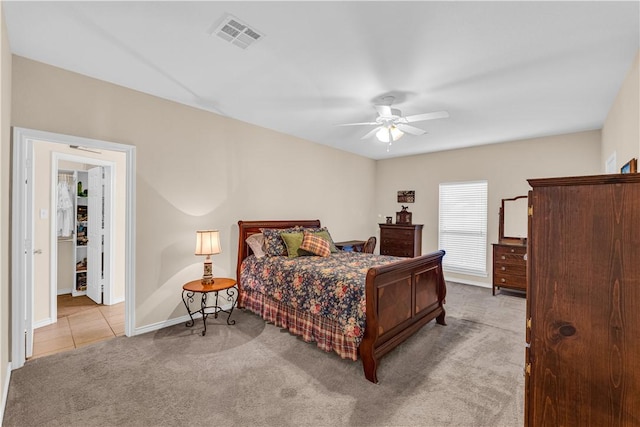 bedroom featuring ceiling fan and light carpet