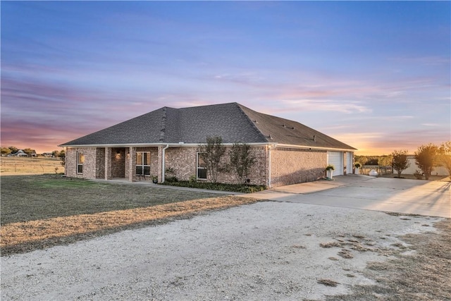 view of front of property with a lawn and a garage