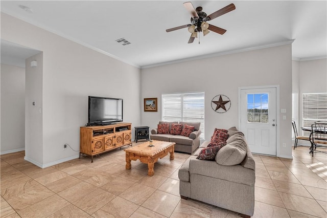 living room featuring ceiling fan, ornamental molding, and light tile patterned floors