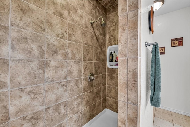 bathroom with tile patterned flooring and a tile shower