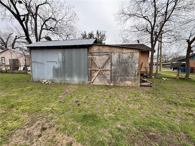 view of outbuilding featuring an outdoor structure and fence