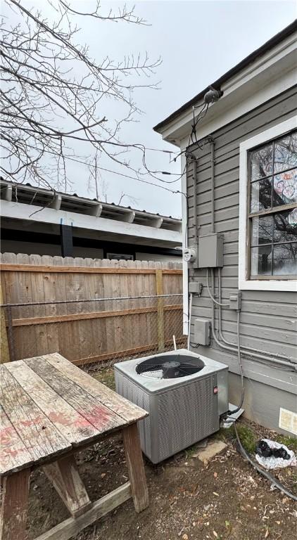 exterior space with fence and central AC