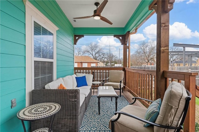 balcony with ceiling fan and an outdoor living space