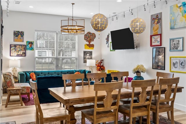 dining room featuring light hardwood / wood-style floors and rail lighting