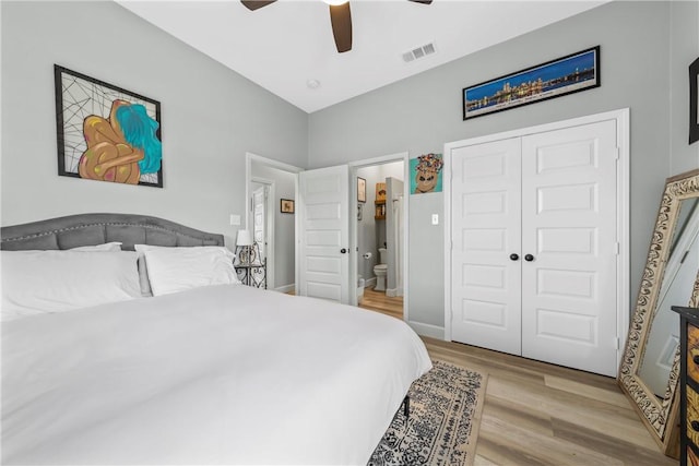 bedroom with ceiling fan, connected bathroom, a closet, and light wood-type flooring