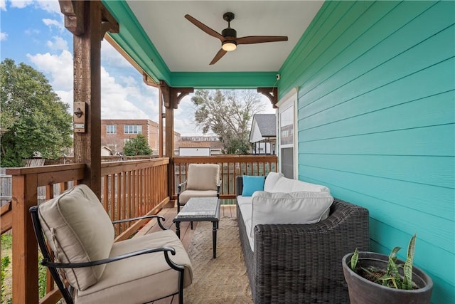 balcony featuring ceiling fan and an outdoor living space