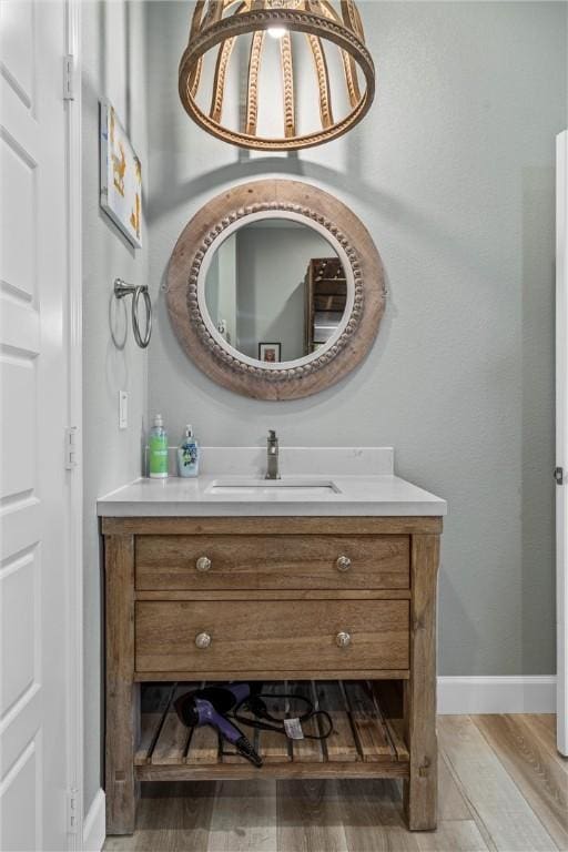 bathroom with hardwood / wood-style flooring and vanity