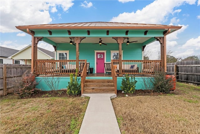 view of front of property featuring ceiling fan and a front lawn