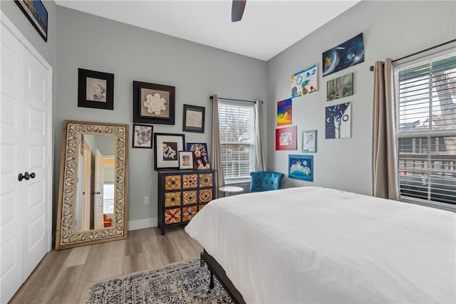 bedroom with ceiling fan and light hardwood / wood-style floors