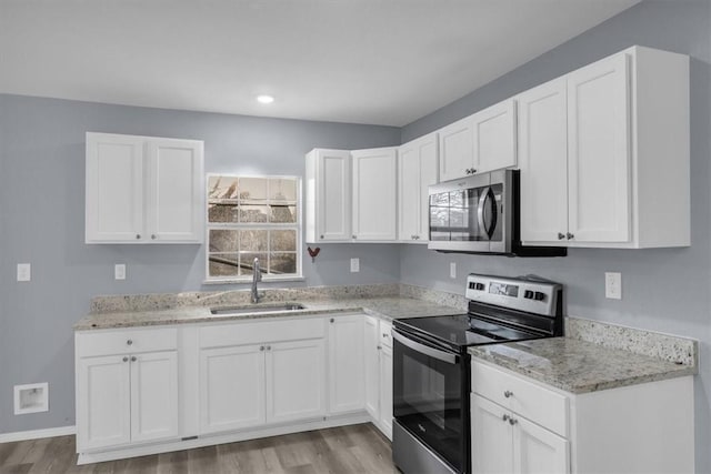 kitchen with white cabinetry, appliances with stainless steel finishes, and sink