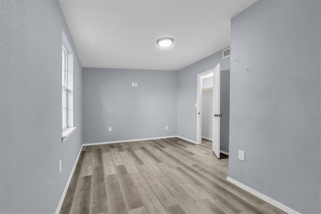 spare room with light hardwood / wood-style flooring