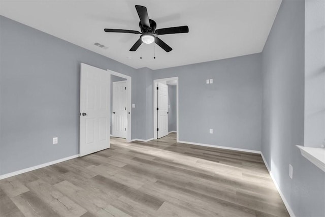 unfurnished bedroom with ceiling fan and light wood-type flooring