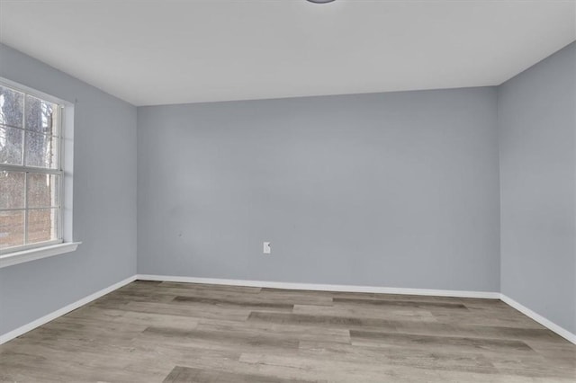 empty room with light hardwood / wood-style flooring