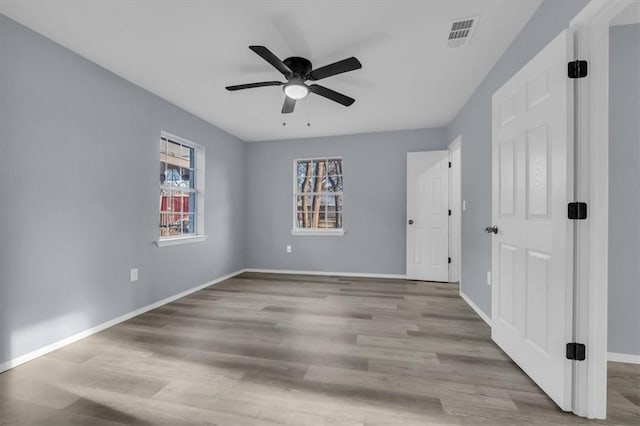 empty room featuring ceiling fan and light hardwood / wood-style floors