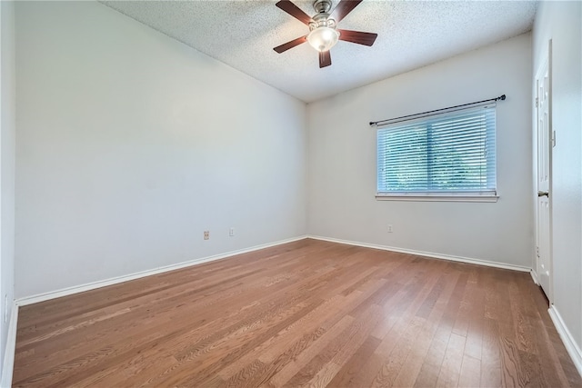 unfurnished room featuring ceiling fan, hardwood / wood-style floors, and a textured ceiling