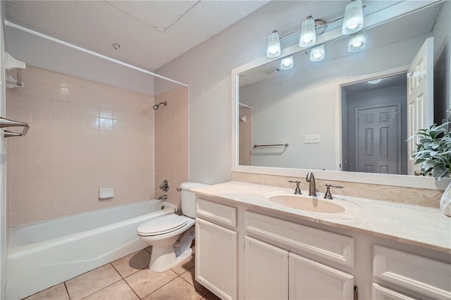 full bathroom featuring tile patterned flooring, vanity, toilet, and tiled shower / bath combo