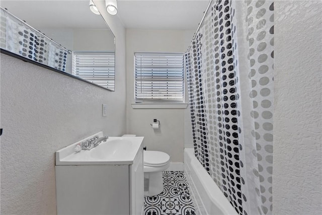 full bath featuring a textured wall, toilet, shower / tub combo, vanity, and tile patterned floors