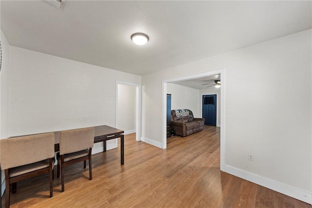 dining space featuring light wood-style floors, visible vents, and baseboards