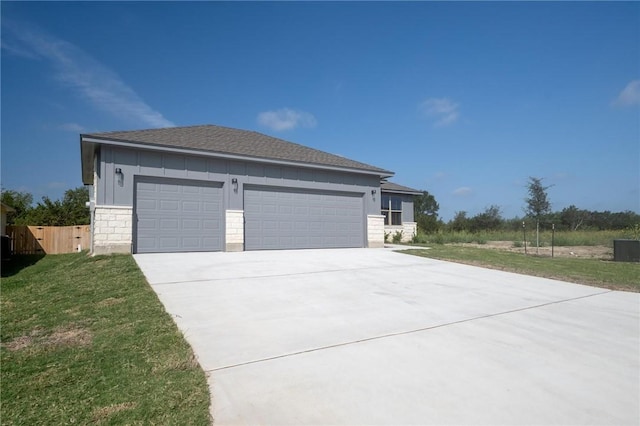 view of home's exterior with board and batten siding, concrete driveway, a lawn, and an attached garage