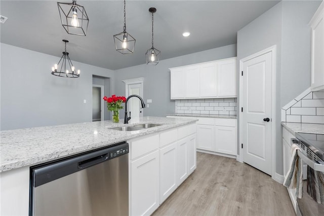 kitchen featuring white cabinetry, hanging light fixtures, and appliances with stainless steel finishes