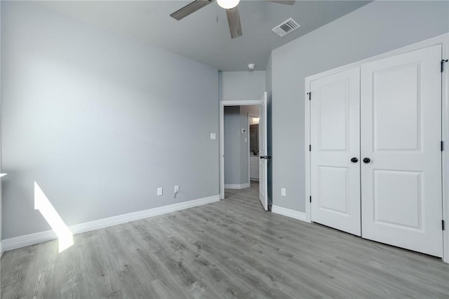 unfurnished bedroom with a closet, ceiling fan, and light hardwood / wood-style flooring