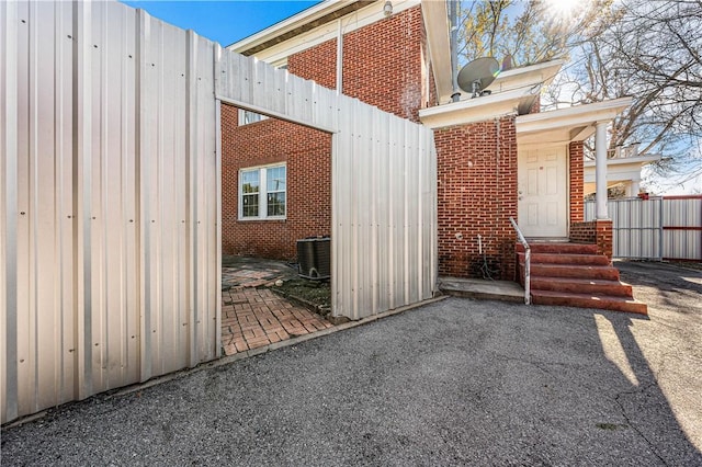 view of side of property featuring central AC and a patio area